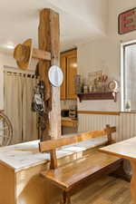 Dining space featuring a wainscoted wall and light wood-style flooring