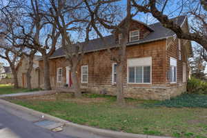 View of front of home with roof with shingles