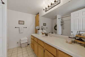 Bathroom with vanity, light tile patterned flooring, and a shower with curtain