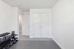 Exercise area with light colored carpet and baseboards