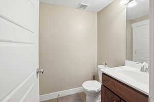 Half bathroom with vanity, a textured ceiling, and light tile patterned flooring