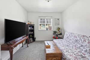 Sitting room with light colored carpet and baseboards