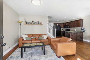 Living room featuring dark wood finished floors and recessed lighting