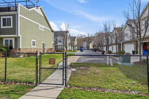 View of yard featuring a residential view and a gate