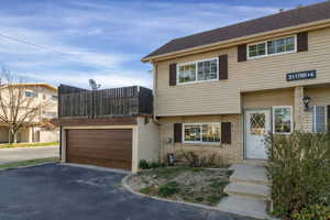 View of front of house featuring brick siding, a garage, and asphalt driveway