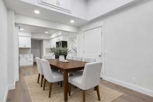 Dining space with light wood-style floors and recessed lighting