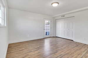 Unfurnished bedroom with light wood-style floors and a closet