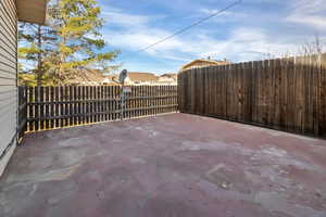 Fenced backyard featuring a patio and a residential view