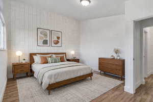 Bedroom with tile walls and wood finished floors