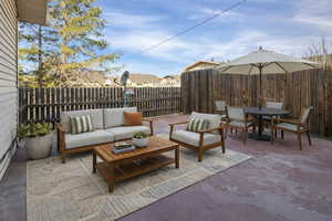 Fenced backyard with a patio and an outdoor living / dining area