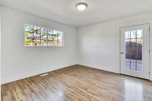Empty room featuring light wood finished floors and baseboards