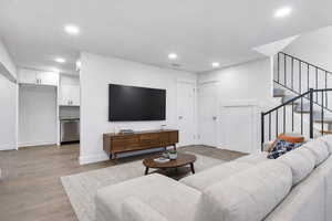 Living room featuring wood finished floors and recessed lighting