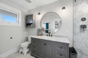 Bathroom featuring vanity and a shower
