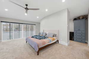 Bedroom with lofted ceiling, ceiling fan, light colored carpet, and recessed lighting