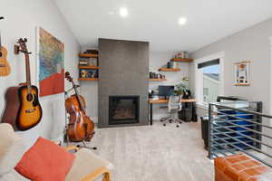 Office area with a tile fireplace, light carpet, and recessed lighting