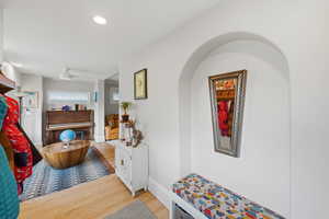 Corridor featuring light wood-type flooring and recessed lighting