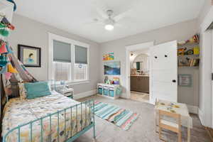 Bedroom featuring light carpet and a ceiling fan