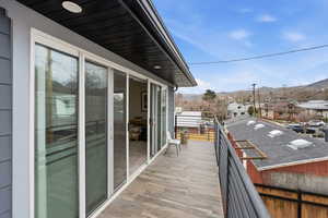 Balcony featuring a residential view and a mountain view