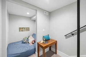 Bedroom featuring carpet floors and baseboards
