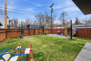 Fenced backyard with a patio