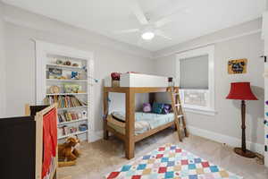 Bedroom featuring light carpet and a ceiling fan