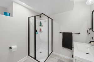 Bathroom with vanity and a stall shower