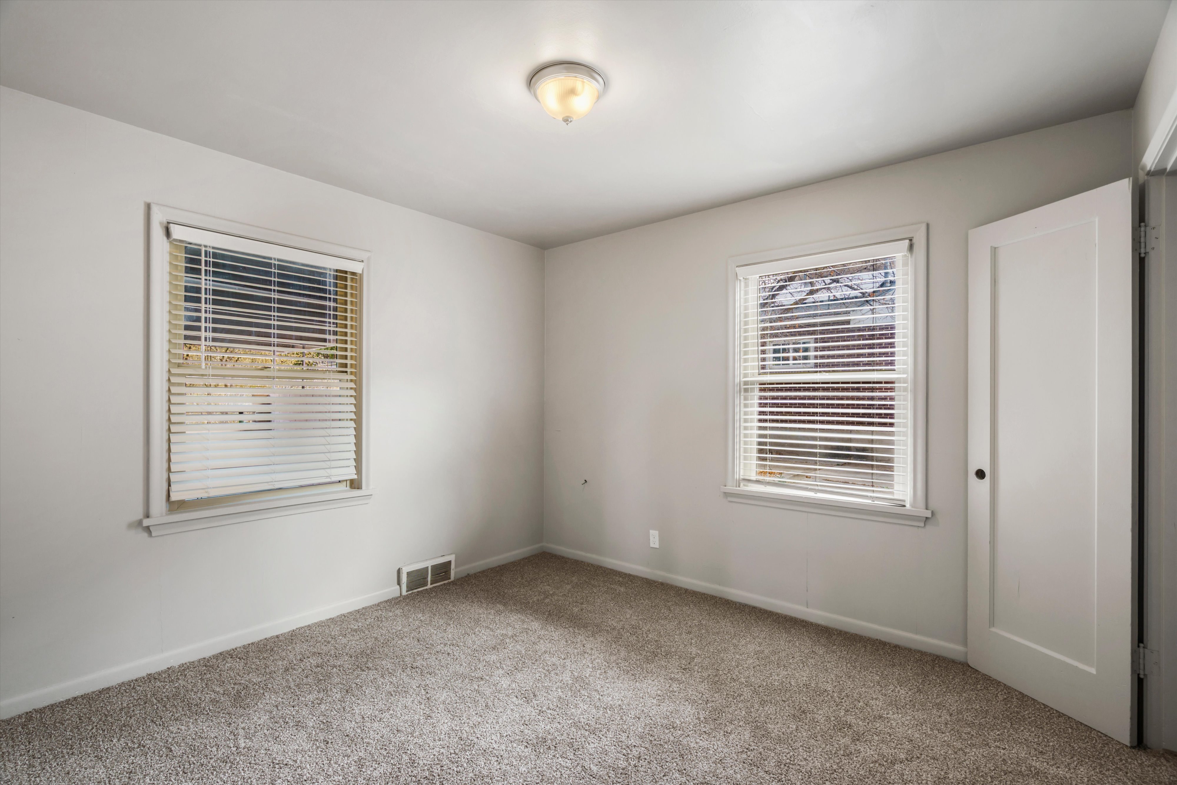 Spare room featuring carpet and baseboards