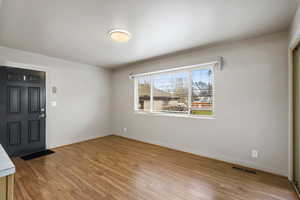 Unfurnished room with light wood-type flooring