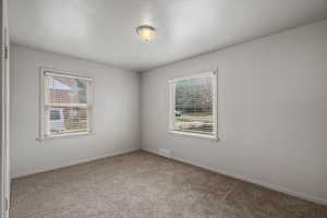 Unfurnished room with carpet flooring and baseboards