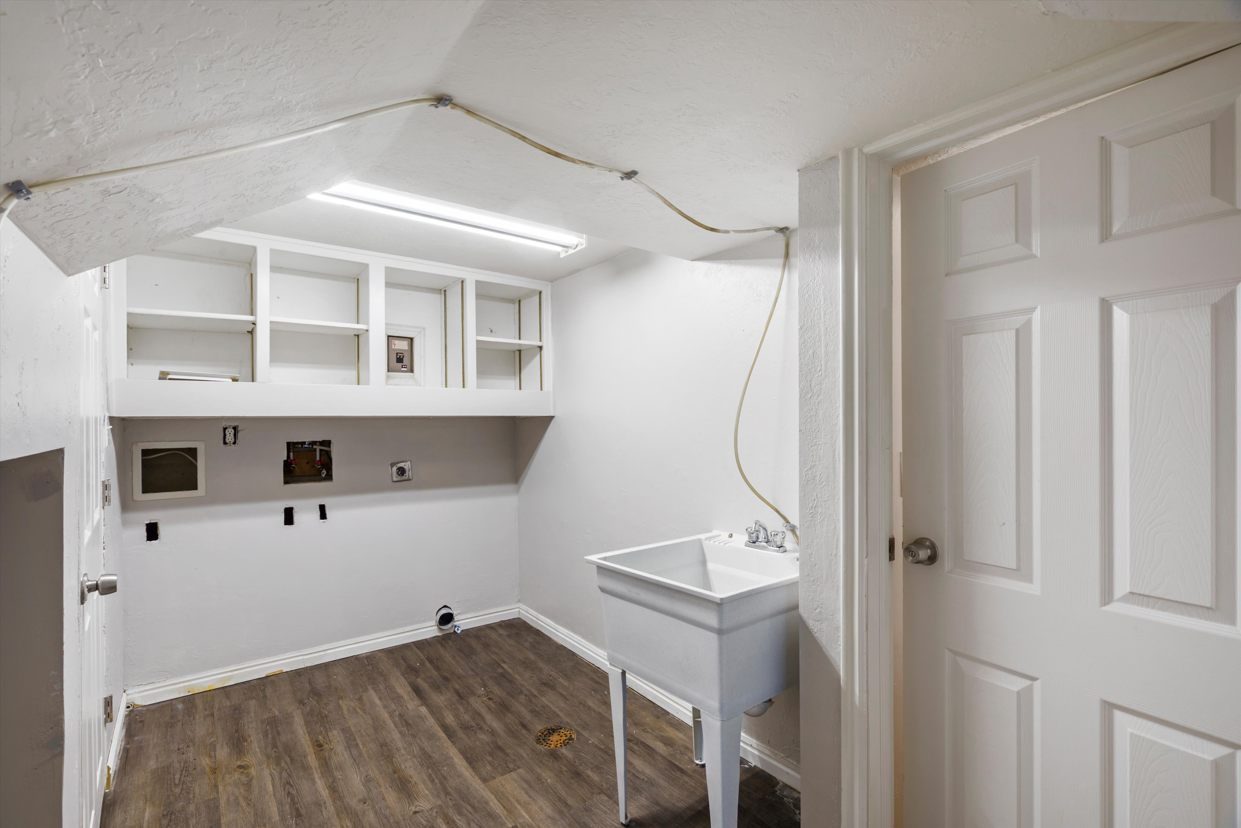 Laundry room with dark wood-style flooring, hookup for a washing machine, and hookup for an electric dryer