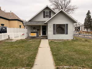 Bungalow-style home featuring covered porch and a chimney