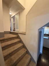 Stairway featuring wood finished floors and baseboards