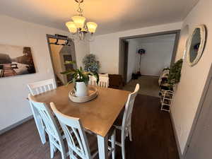 Dining area with wood finished floors and suspended lighting