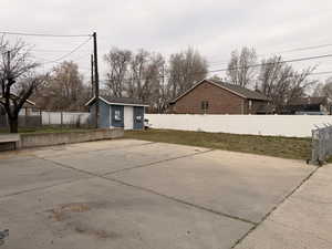 Fenced backyard with a storage shed