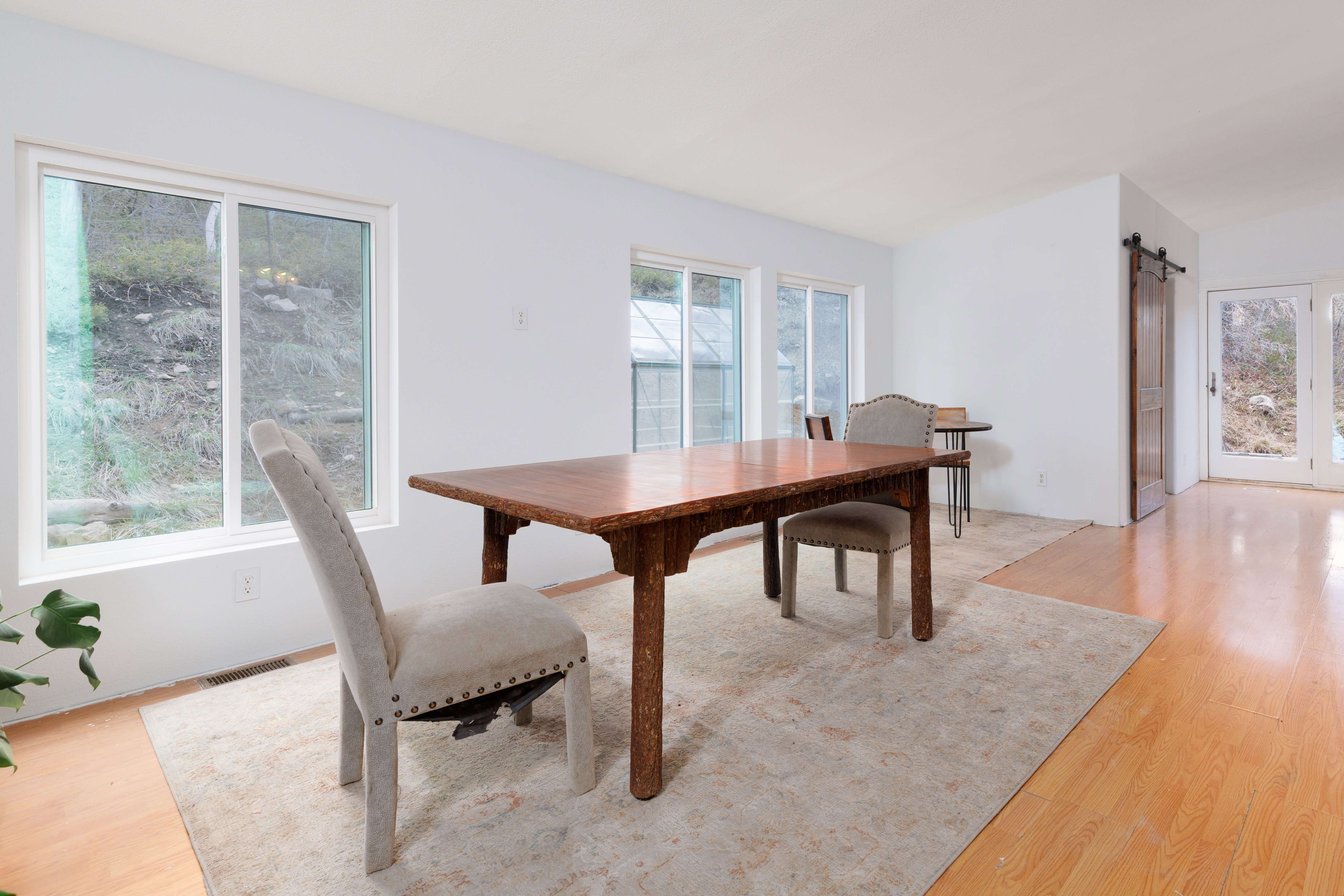 Dining room featuring a barn door and light wood-type flooring