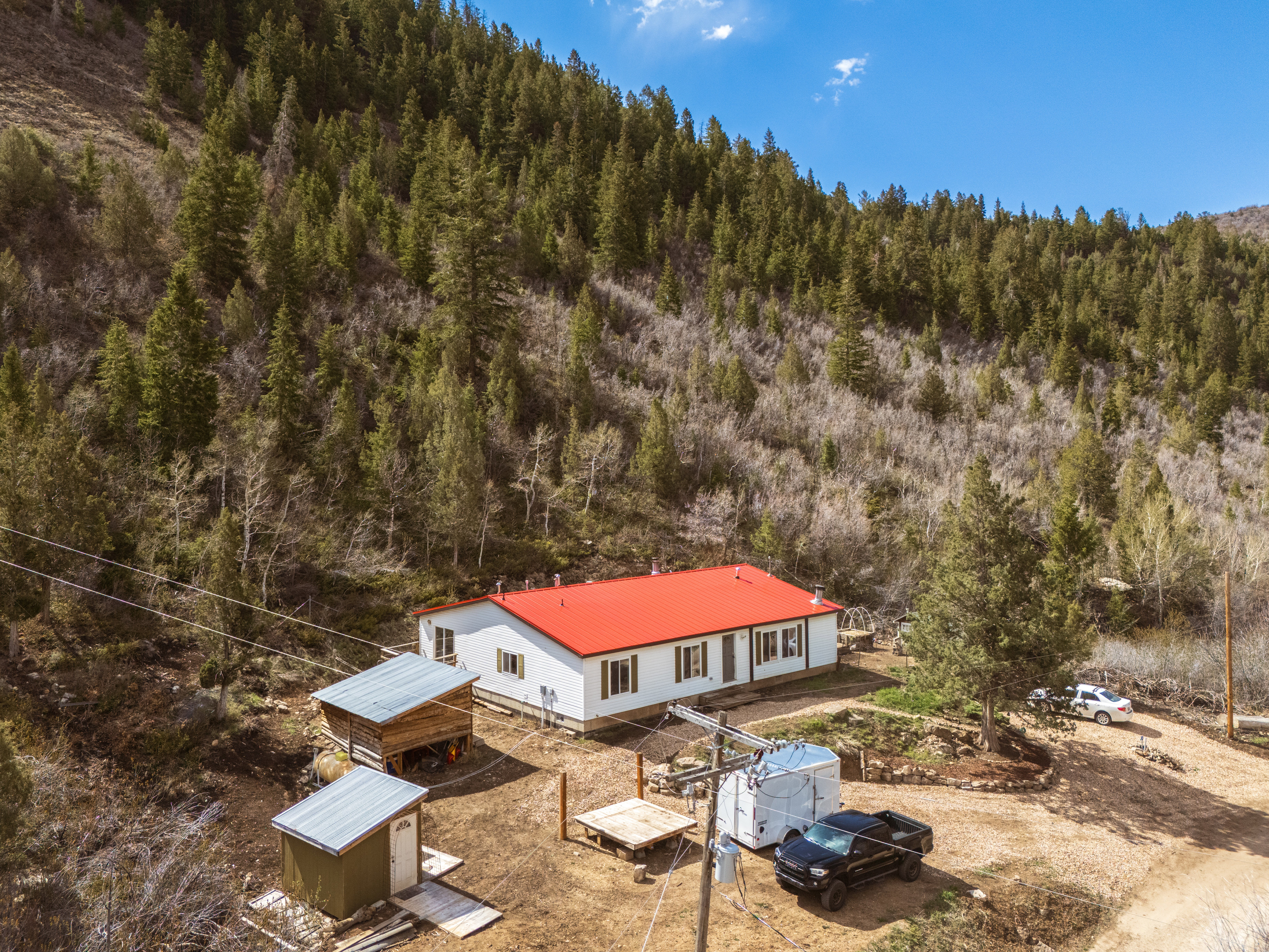 Aerial view of property with red metal roof