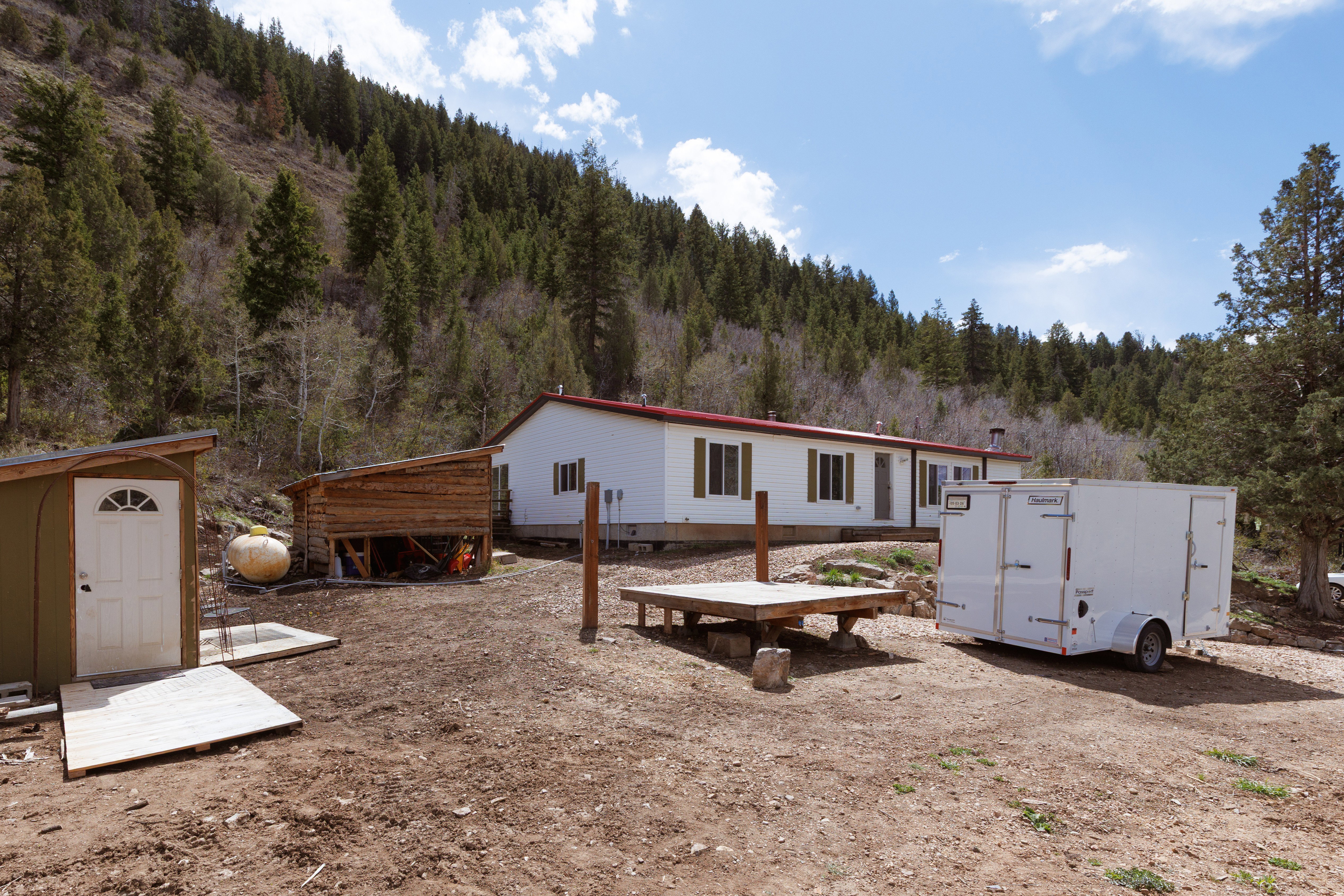 Property view with a shed, accessory building and a forest view