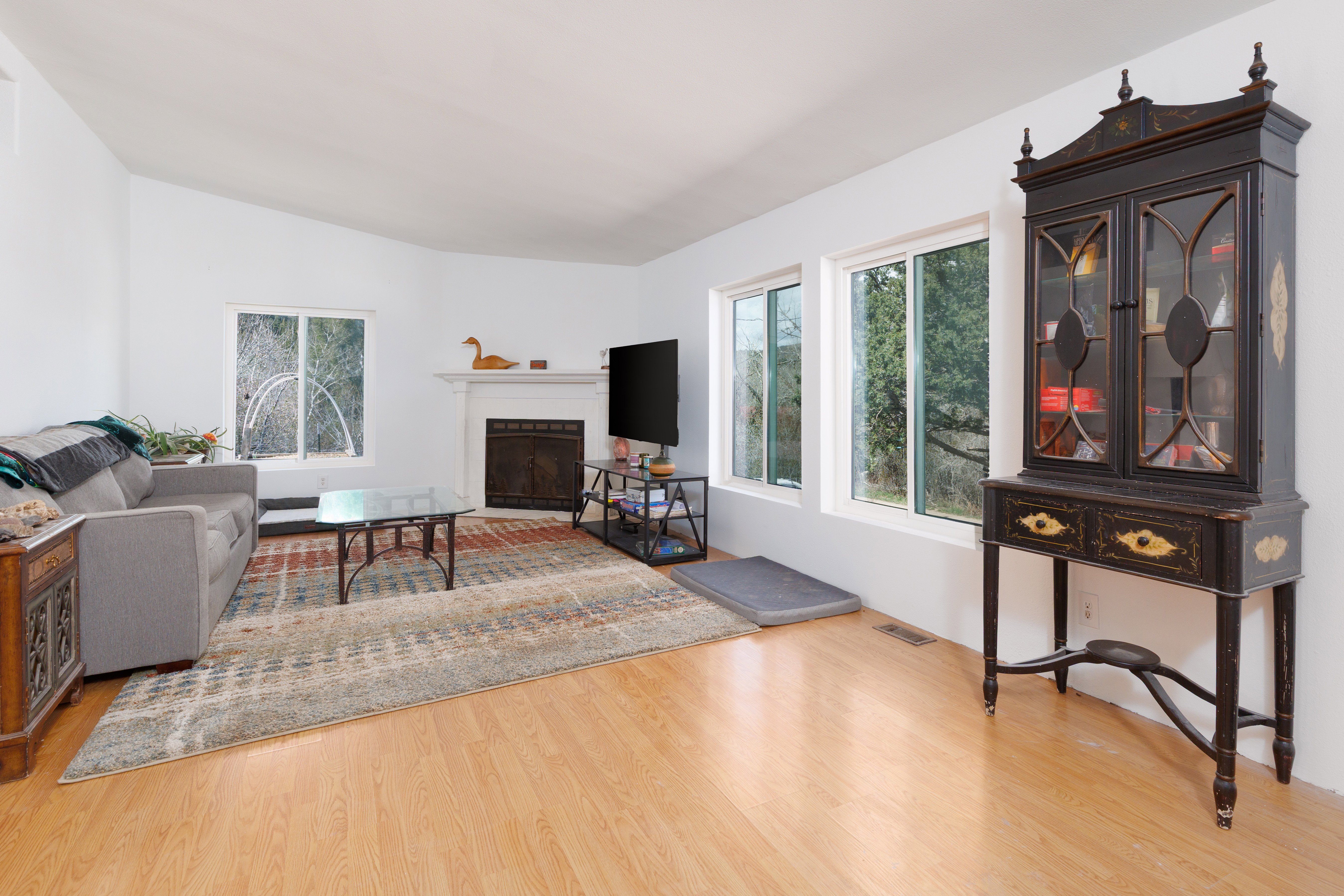 Living area featuring  light wood-style floors and a fireplace with flush hearth