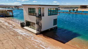 Dock area with view of water and beach