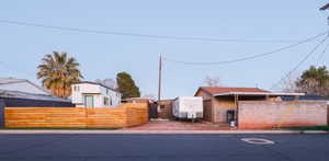 View of front of house featuring a fenced front yard and a gate