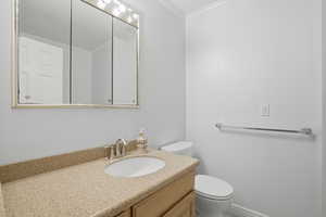 Full bath with vanity and crown molding