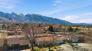 View of mountain backdrop featuring nearby suburban area