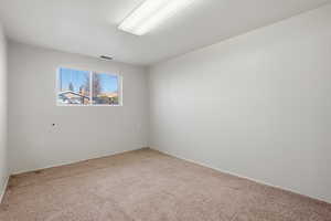Bedroom with light carpet and baseboards
