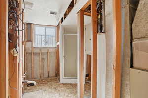 Unfinished bathroom featuring a shower stall