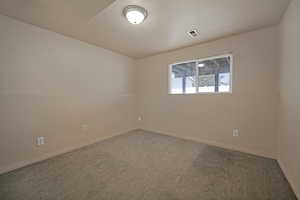 Carpeted empty room with baseboards
