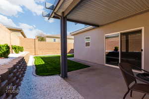 Fenced backyard with a patio
