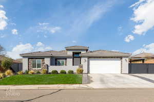 Prairie-style house featuring stone siding, stucco siding, an attached garage, and concrete driveway