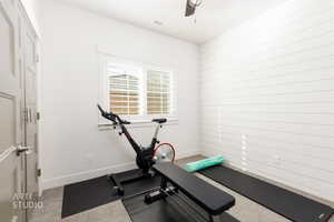 Exercise area with baseboards and ceiling fan