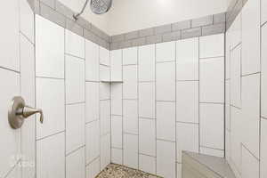 Bathroom featuring tiled shower