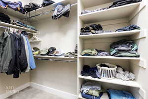 Walk in closet with light carpet